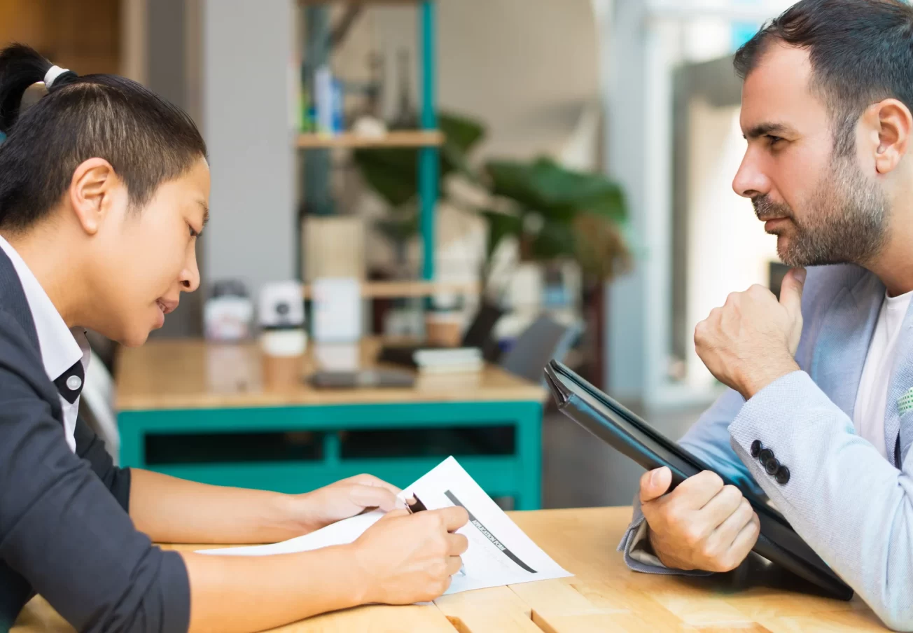 latin-asian-managers-sitting-working-with-documents-office